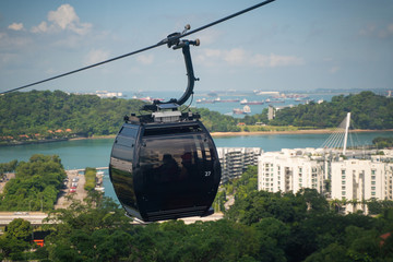 Cable Car overlooking Sentosa Island, Singapore, with beaches, canopy of trees and shipping lanes of in the distance