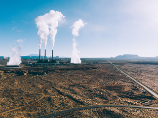 Industrial view of nuclear power station generating radioactive power for country increasing dangerous waste in nature via smoke from towers with steam, plant for generating atomic energy