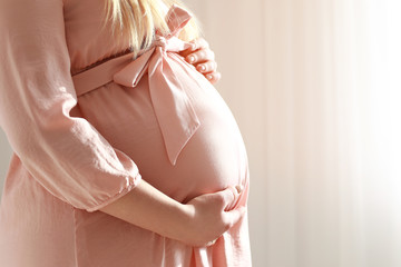 Beautiful pregnant woman at home, closeup