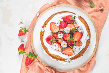 Strawberry cake, strawberry sponge cake with fresh strawberries and sour cream on a white background
