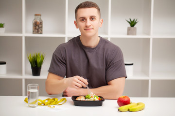 Trainer consumes a high-protein meal of meat and fruit