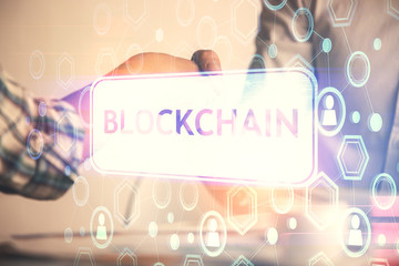 Double exposure of blockchain hologram and handshake of two men. Crypto business concept.