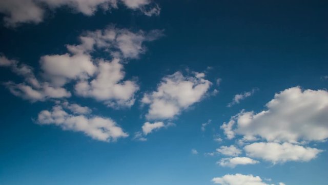Timelapse rolling clouds, Clouds running across brilliant blue sky, Cumulus cloud form against a dark blue sky. Timelapse of white clouds with blue sky.
