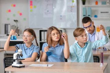 Pupils at chemistry lesson in classroom