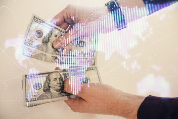 Multi exposure of financial theme drawing hologram and USA dollars bills and man hands. Business concept.