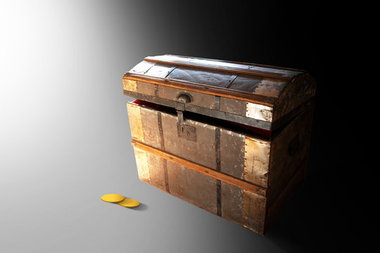 Slightly open treasure chest in bright light , with two gold coins on the floor
