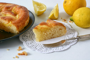 portion of lemon pie on the white table - closeup