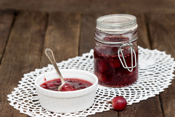 Gooseberry homemade jam in a bowl and glass jar.