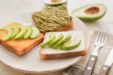 Fototapeta na wymiar Tasty avocado sandwiches on plate