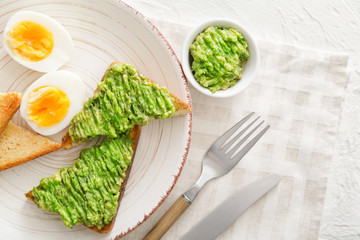 Tasty avocado sandwiches on plate