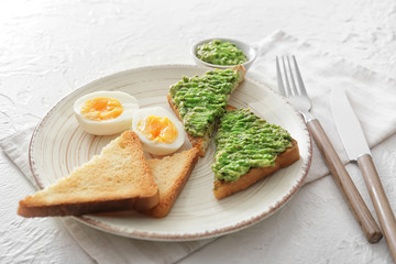 Plate with tasty avocado sandwiches on table