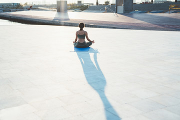 Fototapeta premium Unrecognizable woman sitting in lotus pose