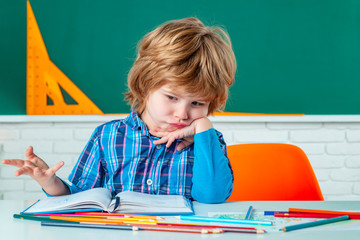 Child home studying and home education. School kids against green chalkboard. Home school for...