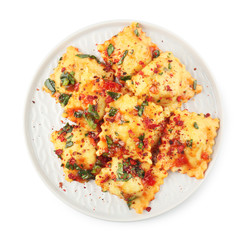 Plate with tasty ravioli on white background