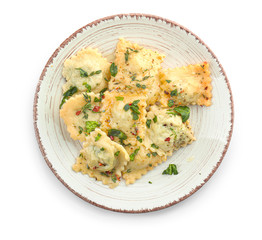 Plate with tasty ravioli on white background