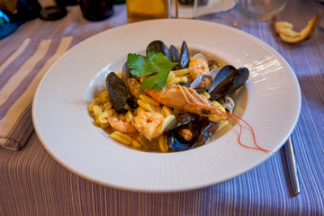Cavaletti Pasta With Seafood and Mussels Served In A Traditional Italian Restaurant