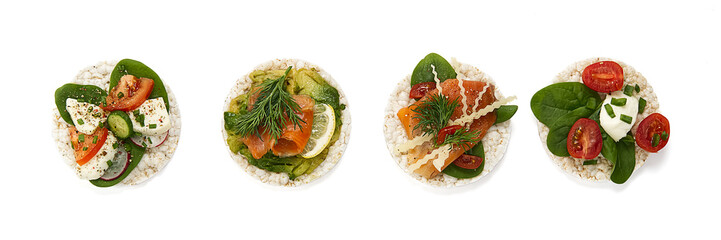 set of rice cakes on white background. healfy food rice cake sandwich isolated on white background. Rice cakes with Basil, tomatoes, avacado, cheese and red trout or salmon fish, mozerella chesse