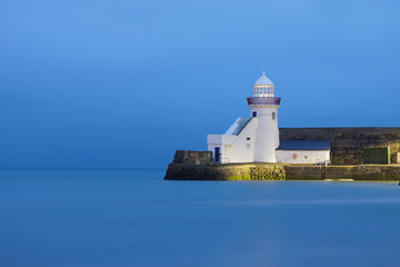 Fototapeta na wymiar Lighthouse in Balbriggan, Ireland calm water, long exposure blue hour