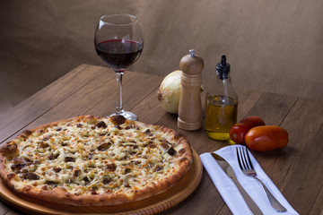 Meat pizza on wooden board. Made with Mozzarella, picanha meat, onion, cheese, tomato sauce. Filet...