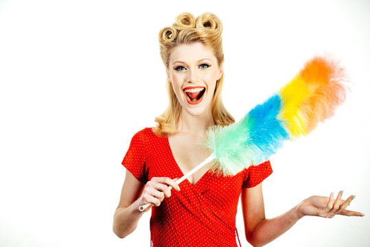 Funny housekeeper. Cleaning service. Smiling girl with equipment for cleaning on white background, isolated.