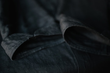 Black linen bartender shirt. Close up view. Smooth image with shallow depth of field.
