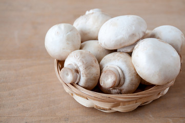 Mushrooms in a basket are on the table