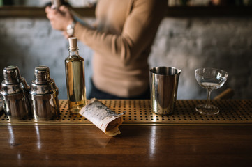 Bartender preparing cocktail based on gin, birch juice and essential oil of frankincense.