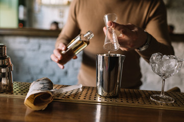 Fototapeta na wymiar Bartender preparing cocktail based on gin, birch juice and essential oil of frankincense.