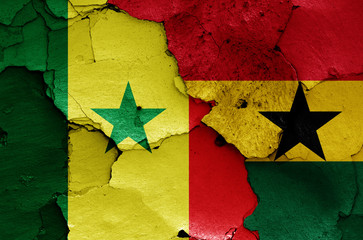 flags of Senegal and Ghana painted on cracked wall