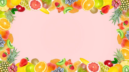 Creative photo of many different exotic tropical bright fruits frame on a summer soft pink color background. View from above. Bright summer fruit pattern with copy space.