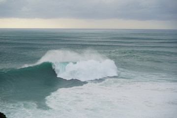 Another huge wave in Nazare. Cloudy day in this beautiful town