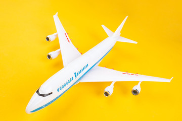 Two-level airliner. Passenger airplane on a yellow background. Model of a two-story aircraft. Concept - flight on a modern airliner. Traveling by plane. Concept - Civil Aviation Development
