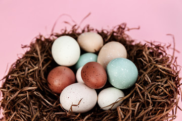 Naklejka na ściany i meble Easter eggs in the nest against pink background, season holiday pattern
