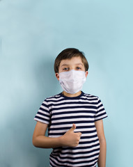 A child in a medical mask on a blue background. Isolated kid