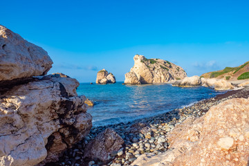 Fototapeta na wymiar Cyprus. Rock Aphrodite. Cliffs on the beach of Cyprus. Aphrodite's stone on the background of blue sky. Tour the Mediterranean Sea. Rocks on the ocean. Scenery. Attractions in the vicinity of Paphos