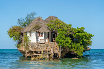 Home on the rock on high tide in sea water on the island of Zanzibar, Tanzania, Africa