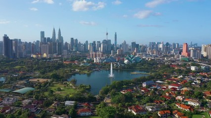 February 23rd, 2020 - Kuala Lumpur, Malaysia : 4k Establishing b-roll aerial shot of drone moving forward towards Kuala Lumpur city skyline. Flying over Titiwangsa Lake. Green and Sustainable City