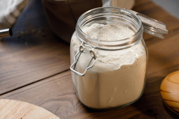 Baking cooking Ingredients flour eggs rolling pin milk and kitchen textile. Side and top view. Delicious food, recipes, cooking, gastronomy, on a dark background and wooden table.