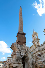 Fototapeta na wymiar Sunny view of Piazza Navona with the Fountain of the Four Rivers (Italian: Fontana dei Quattro Fiumi) with Egyptian obelisk