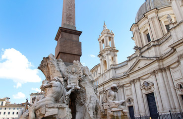 Fototapeta na wymiar Sunny view of Piazza Navona with the Fountain of the Four Rivers (Italian: Fontana dei Quattro Fiumi) with Egyptian obelisk