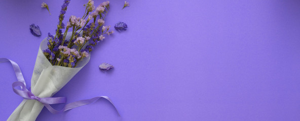 Background with purple flowers and copy space on purple background