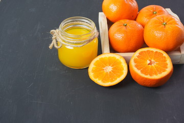 Naklejka na ściany i meble Fresh orange juice and citrus fruits on a simple table