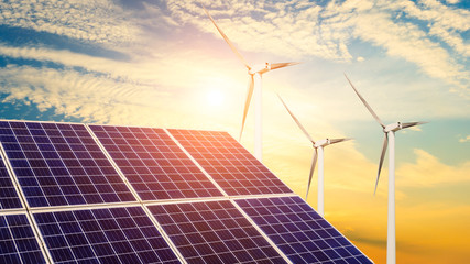 Solar panels with wind turbines in the setting sun,green energy.