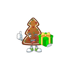 Smiley gingerbread tree cartoon character holding a gift box