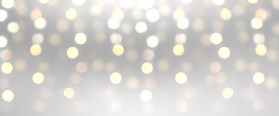 Shimmer sequins abstract pattern. Sparkles on light silver blur background. Holiday decorative banner.