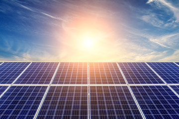 Photovoltaic solar panels on sunset sky background,green clean energy concept.