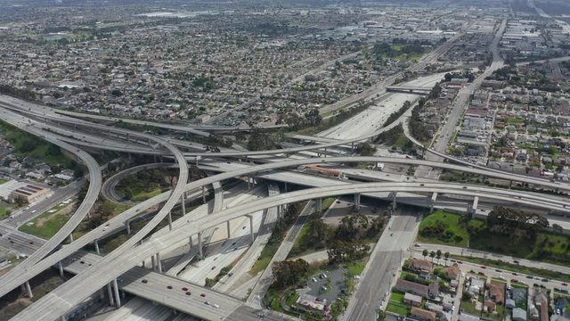 AERIAL: Spectacular Judge Pregerson Highway showing multiple Roads, Bridges, Viaducts with little car traffic in Los Angeles, California on Beautiful Sunny Day 