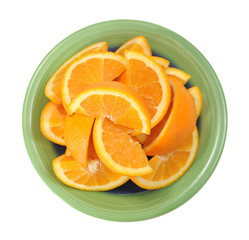 Fototapeta na wymiar cutting orange fruit on green dish isolated on white