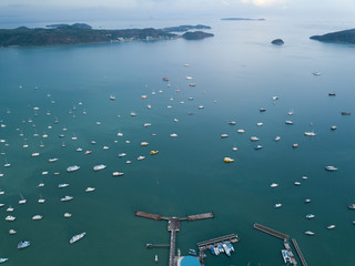 aerial view of the bay with yacht parking, the bay is surrounded by picturesque mountains, cloudy weather at sunset, Chalong bay Phuket Thailand