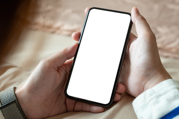 Cropped shot of professional woman holding blank screen smartphone in bedroom at home